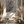 Entfaltung 2 abstract art with black and blue branches on beige canvas, displayed above wooden bench with pampas grass decor