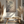 Entfaltung 1 abstract art with dark branches on beige canvas, displayed above wooden bench with pampas grass decor